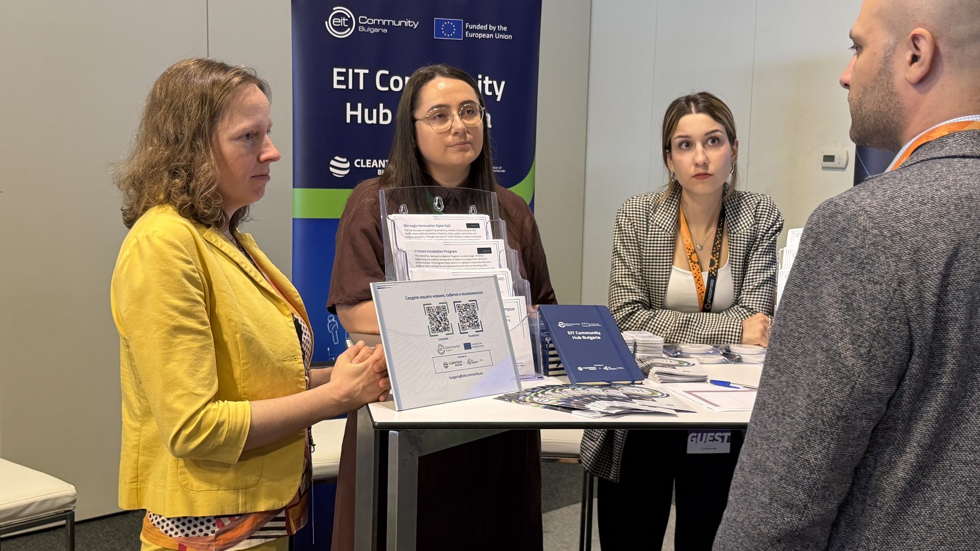 EIT Community Hub Bulgaria team engaging with a visitor at the Green Transition Forum 6.0 booth in Sofia