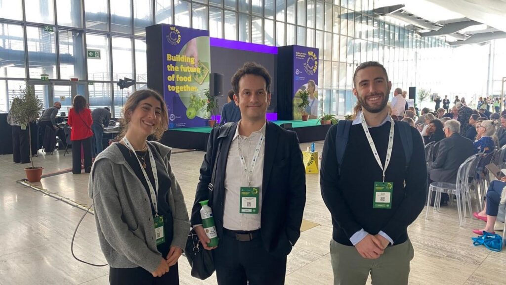 The Magfi team at EIT Food's Next Bite event in Rome, in front of the Building the future of food together stage