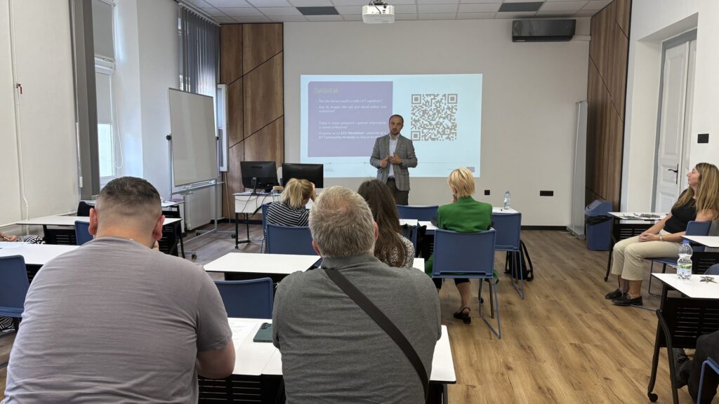 Presenter at the EIT Community Hub Croatia event in Osijek speaking in front of a projected slide